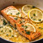 Salmon fillet cooked in lemon garlic butter sauce with lemon slices